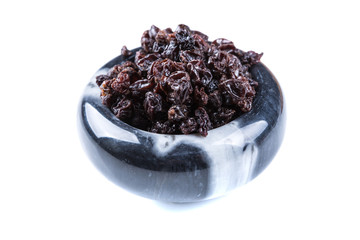Black organic zante currants isolated on a white background
