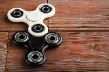 Fidget spinner toys on brown wooden table