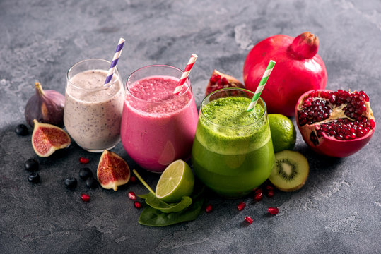 Colorful smoothies with pomegranate, blueberries and spinach, healthy detox vitamin antioxidant drink diet or vegan food concept