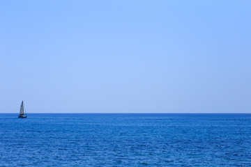 Lonely yacht and sparkling water of Mediterranean Sea.