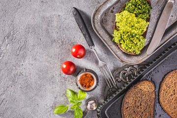 Pesto toasts on vintage tray top view with copy space
