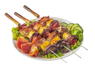Pork, pineapple and red onion kebabs skewers on plate isolated on white
