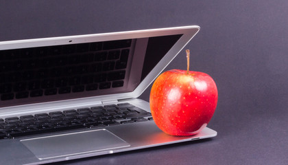 Modern laptop computer on dark background.