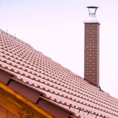 new house with orange brick wall, roof and chimney. House building worker concept.