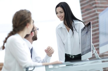 young business woman talking to colleagues in the office