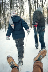 two boys riding in sleigh in winter