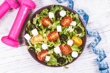 Greek salad with fresh vegetables, feta cheese and black olives.