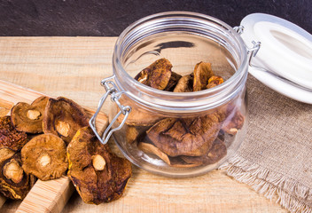 Dried forest mushrooms on a wooden table.