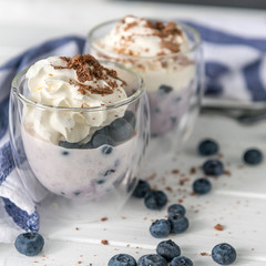 Dessert from yogurt with blueberries and chocolate 