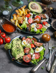 Vegetarian dinner - fried potatoes and fresh vegetable salad