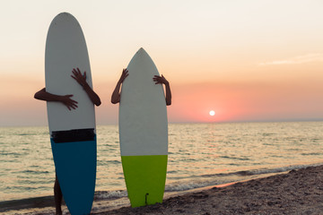 Young couple of surfers