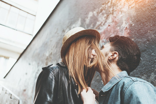 Young Couple In Love Walking Together On The Street. Kissing And Hugging, Enjoying Sunny Day.