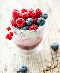 Fototapeta na wymiar Dessert from yogurt with chia seeds, raspberries and blueberries