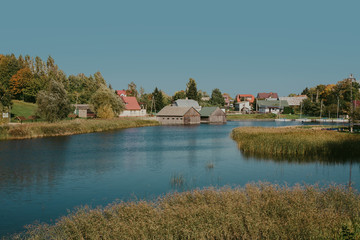 Fototapeta na wymiar Sunny autumn in Poland. Blue sky over the lake.