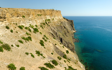 Fiolent Cape Crimea Black Sea. Blue azure seaside with corals sand and stones