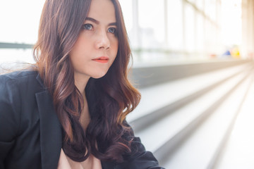 Beautiful Asia business woman over blue office background.