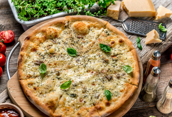 Pizza four cheeses on the table