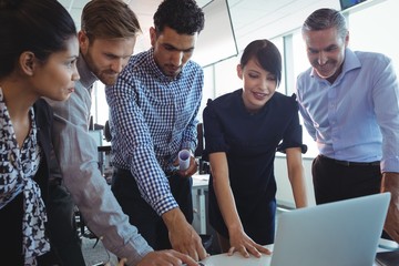 Business colleagues working together on laptop