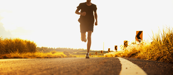 The man with runner on the street be running for exercise.
