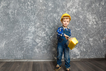 the boy in yellow hard hat and a yellow tool box