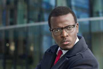 Close up portrait of angry african american boss with serious face expression. Copy space for your text.