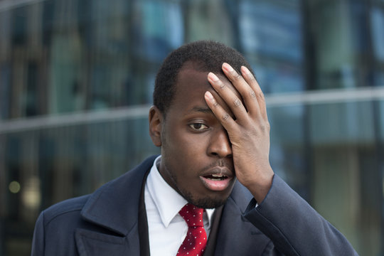 Close Up Portrait Of African American Businessman With Face Palm Gesture. Disappointed Stressed Out Black Business Man Making Facepalm With Hand.