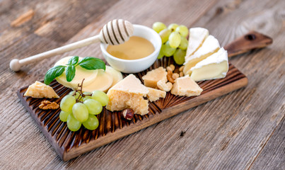 Cheese plate served with nuts and honey