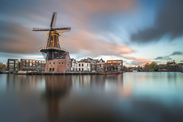 Landmark windmill De Adriaan in Haarlem Holland, The Netherlands. On the Spaarne River, canal with restaurant Zuidam