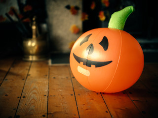 Halloween pumpkin balloon on wooden floor