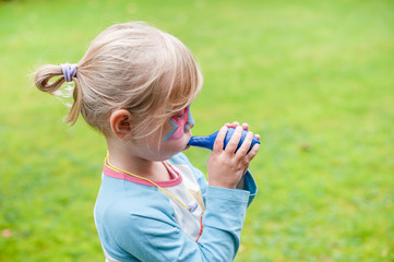 Child trying to blow up a balloon