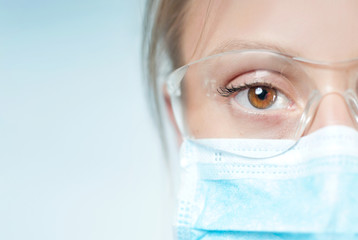 Portrait of young specialist with protective glasses and mask.