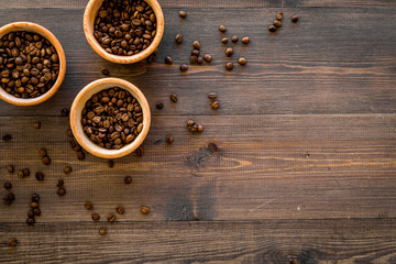 Ingredients for coffee. Roasted coffee beans on wooden background top view copyspace