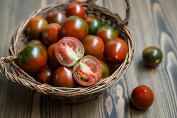 Kumato tomatoes in a braided willow bowl