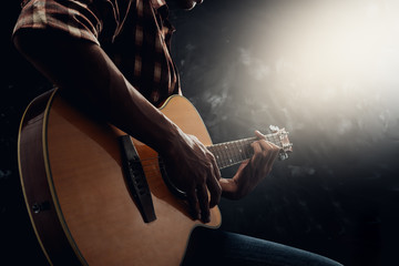 Man playing guitar on the style own.