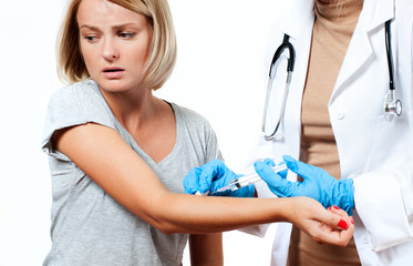 Vaccination. Doctor injecting flu vaccine to patient's arm