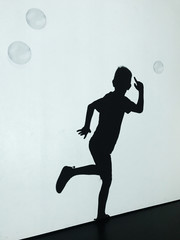 Silhouette of a dancing boy during party