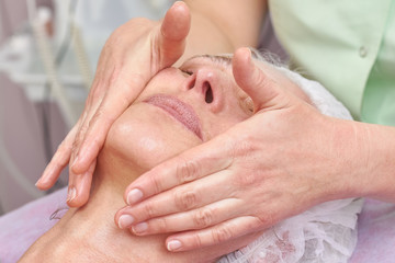 Close up of facial massage. Face massage, female hands.