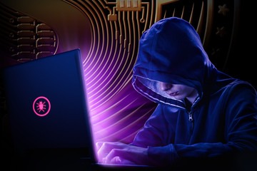 Arrested computer hacker and cyber criminal with handcuffs wearing hooded jacket hiding face