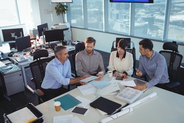 Business people discussing in meeting at office desk