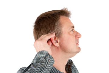 Fototapeta premium Man adjusting his hearing aid. Isolated on white.