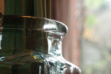 closeup of vintage bottle against a blurred window background