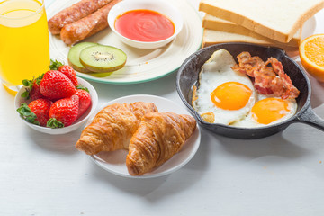 Nutritious breakfast, strawberry, bread, coffee orange juice, sausage, egg