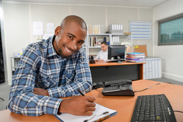 Writing on his clipboard