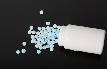 blue pills scattered on the table.