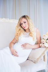 Beautiful pregnant woman in waiting for the baby. Pregnancy. Care, tenderness, maternity, childbirth.