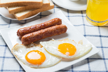 Nutritious breakfast, strawberry, bread, coffee orange juice, sausage, egg