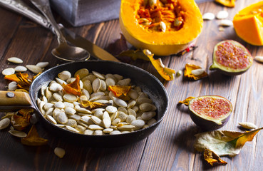 pumpkin seeds grain harvest vitamins vegetables wooden background
