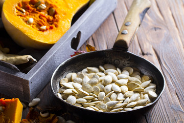 pumpkin seeds grain harvest vitamins vegetables wooden background

