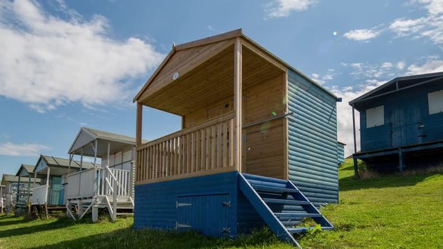 Time lapse of traditional english beach huts in whistable, kent, england on a summer's day