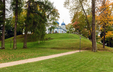 Fototapeta na wymiar Autumn park with orthodox church on a background in Cesis town, Latvia